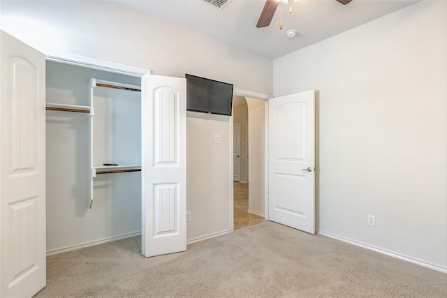 unfurnished bedroom featuring a closet, carpet flooring, baseboards, visible vents, and a ceiling fan