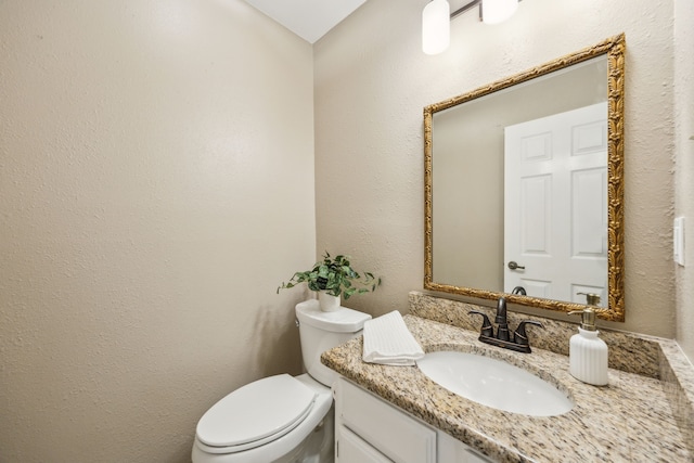 bathroom with toilet and vanity