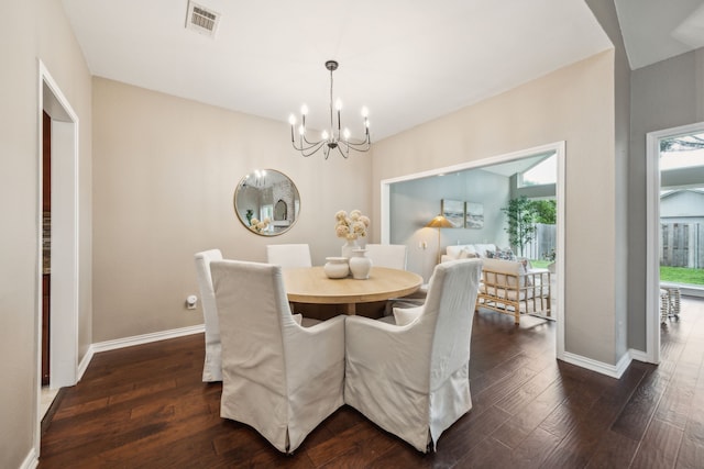 dining room with visible vents, dark wood-style flooring, a chandelier, and baseboards