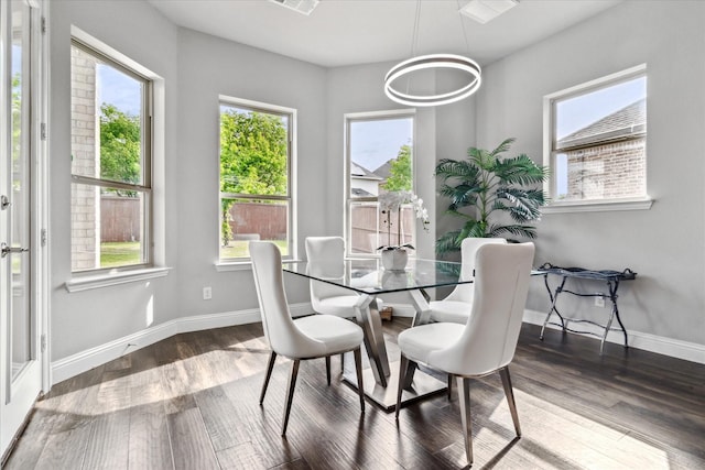 dining room featuring wood finished floors and baseboards