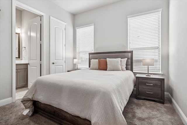 bedroom with multiple windows, baseboards, and light carpet