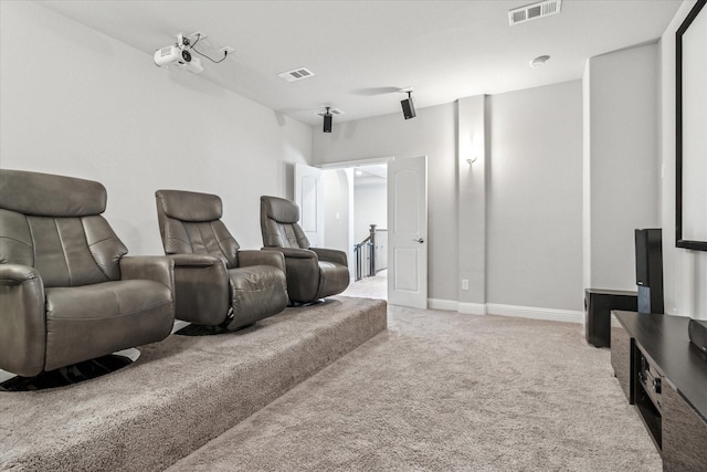 home theater room featuring carpet flooring, visible vents, and baseboards