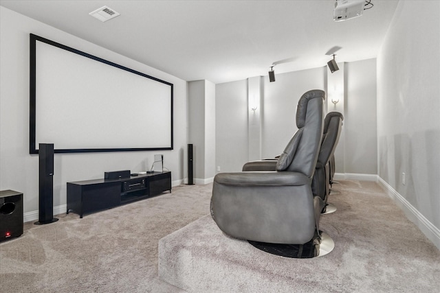 carpeted home theater with visible vents and baseboards