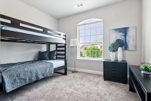 bedroom featuring baseboards, visible vents, and carpet