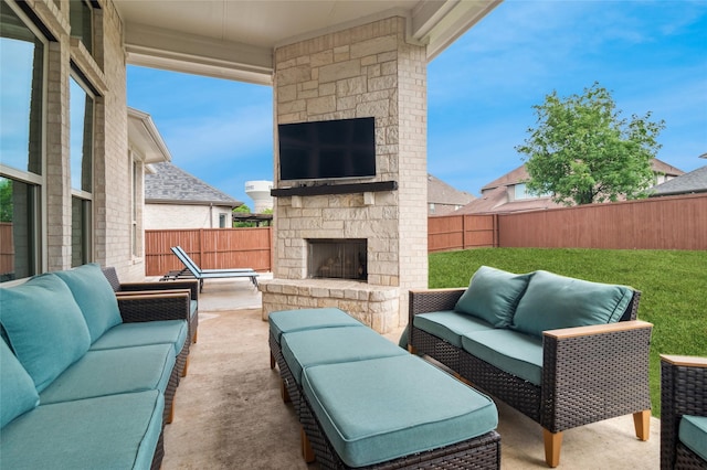 view of patio / terrace with an outdoor living space with a fireplace and a fenced backyard