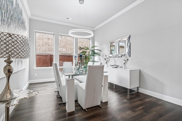 dining area featuring visible vents, crown molding, dark wood-style floors, and baseboards