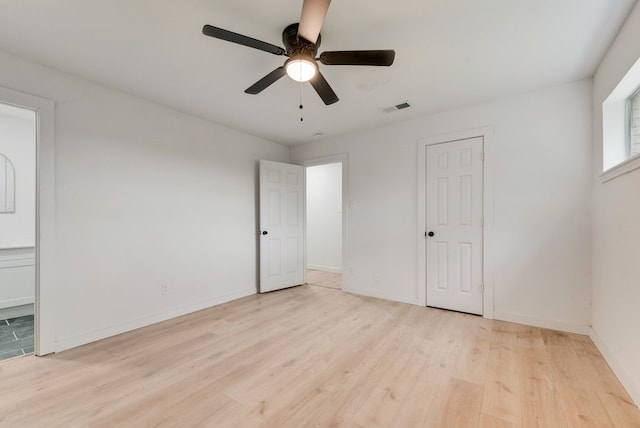 unfurnished bedroom with visible vents, ceiling fan, light wood-style flooring, and baseboards