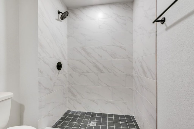 full bathroom with toilet and a tile shower