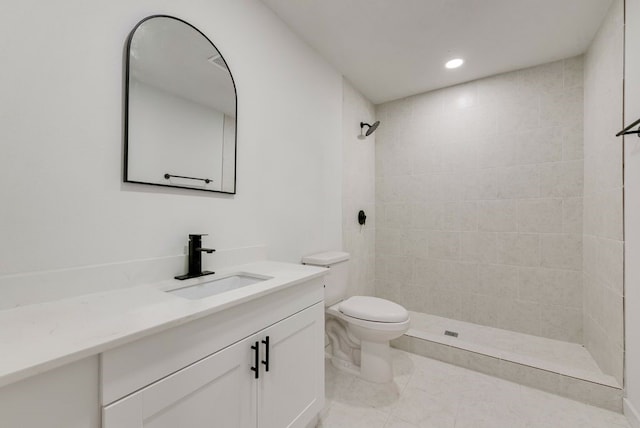 bathroom with toilet, vanity, recessed lighting, and tiled shower