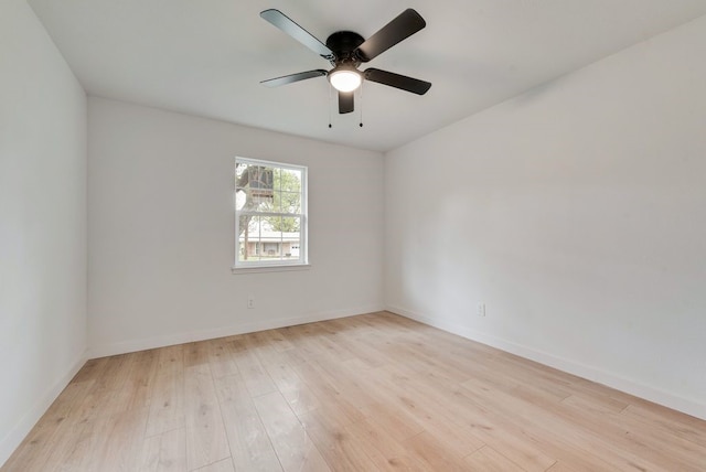 empty room featuring light wood finished floors, ceiling fan, and baseboards