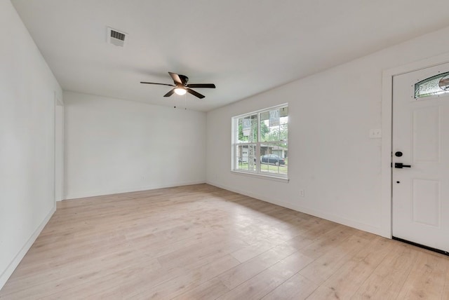 foyer featuring visible vents, a ceiling fan, light wood-style flooring, and baseboards