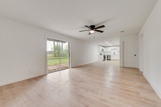 unfurnished living room with ceiling fan, baseboards, and light wood-type flooring