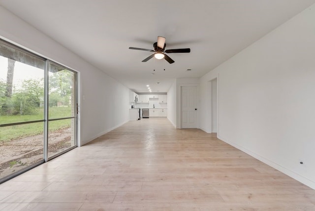 unfurnished living room featuring baseboards, ceiling fan, and light wood finished floors