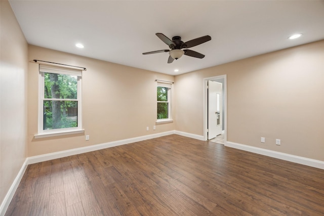 spare room with a healthy amount of sunlight, baseboards, and wood finished floors