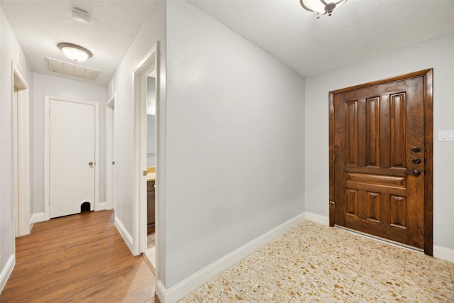 entryway with baseboards and visible vents