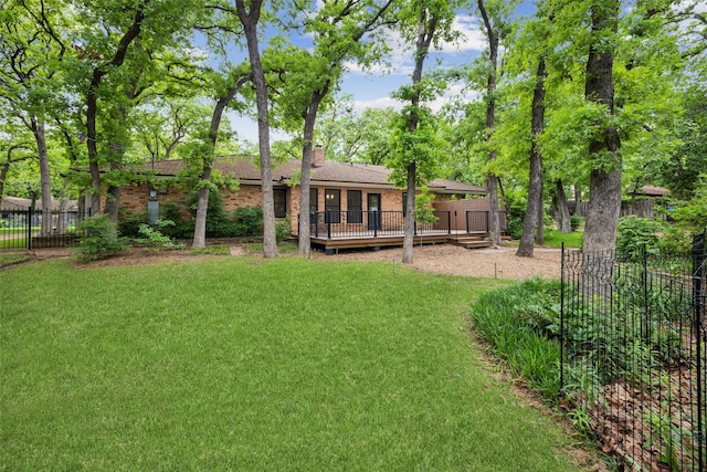 view of yard with fence and a wooden deck
