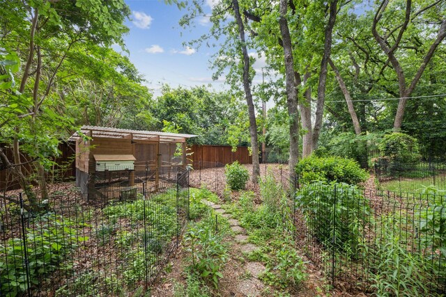 view of yard with exterior structure, fence, and an outdoor structure