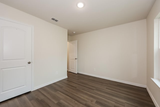 unfurnished bedroom with recessed lighting, visible vents, dark wood-style flooring, and baseboards