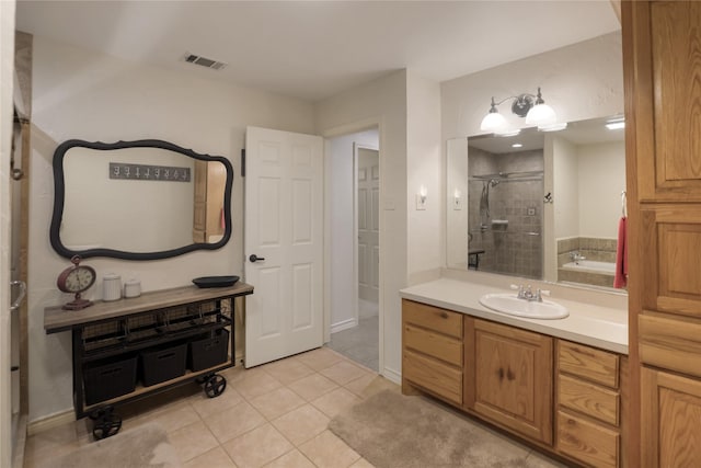 full bathroom featuring vanity, tile patterned floors, a shower stall, and visible vents