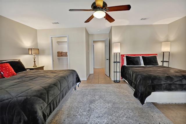 bedroom with baseboards, a ceiling fan, light tile patterned flooring, and visible vents