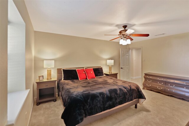 carpeted bedroom featuring ceiling fan and visible vents