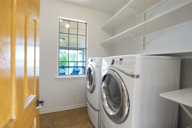 clothes washing area with laundry area, tile patterned flooring, baseboards, and washing machine and dryer