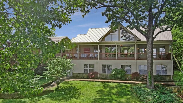 rear view of house featuring a standing seam roof and metal roof