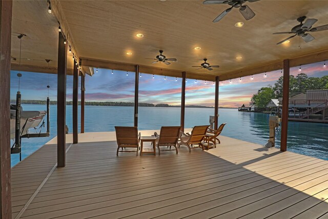 dock area with boat lift and a water view