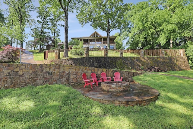 view of yard featuring fence and a fire pit