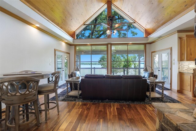 living room with wood ceiling, a ceiling fan, crown molding, high vaulted ceiling, and dark wood-style floors