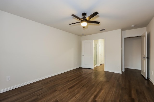unfurnished bedroom featuring baseboards, ceiling fan, dark wood-style flooring, and visible vents