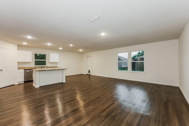 unfurnished living room featuring recessed lighting, visible vents, a sink, and dark wood-type flooring