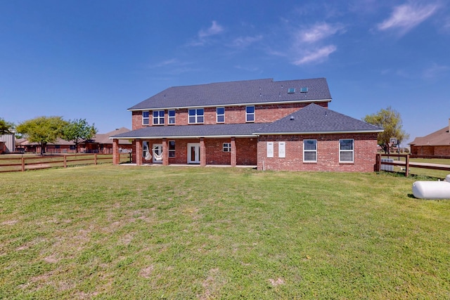 2609 Comanche Moon Dr, Fort Worth, TX 76179 - rear view of house featuring a lawn, brick siding, and a fenced backyard