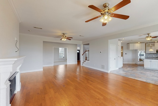 2609 Comanche Moon Dr, Fort Worth, TX 76179 - unfurnished living room featuring stairway, crown molding, a fireplace, and a ceiling fan