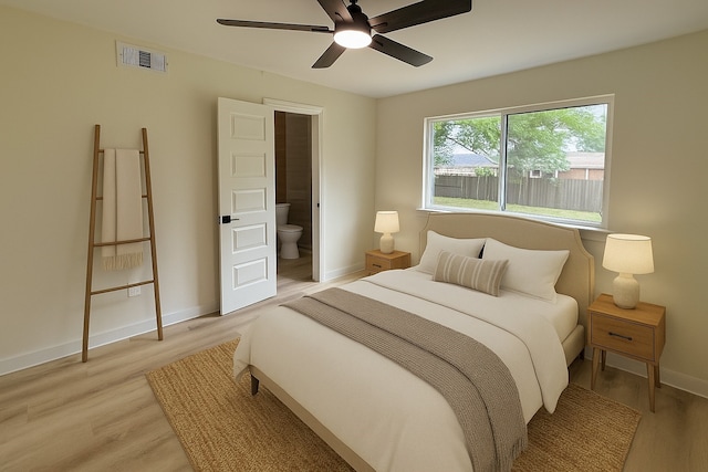 1830 Bosque Dr, Garland, TX 75040 - bedroom with light wood-style flooring, ensuite bathroom, and ceiling fan