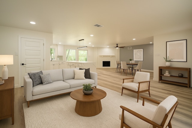 1830 Bosque Dr, Garland, TX 75040 - living area featuring light wood-style floors, ceiling fan, recessed lighting, and a large fireplace