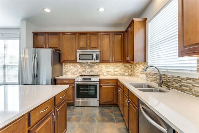 kitchen featuring appliances with stainless steel finishes, light countertops, and a sink