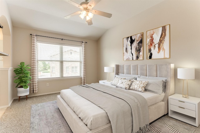 bedroom featuring baseboards, light colored carpet, ceiling fan, and lofted ceiling