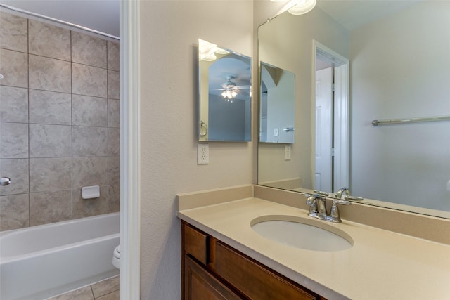 full bathroom with washtub / shower combination, ceiling fan, toilet, tile patterned floors, and vanity