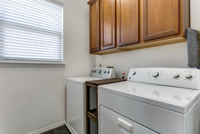 laundry room featuring baseboards, washer and dryer, and cabinet space