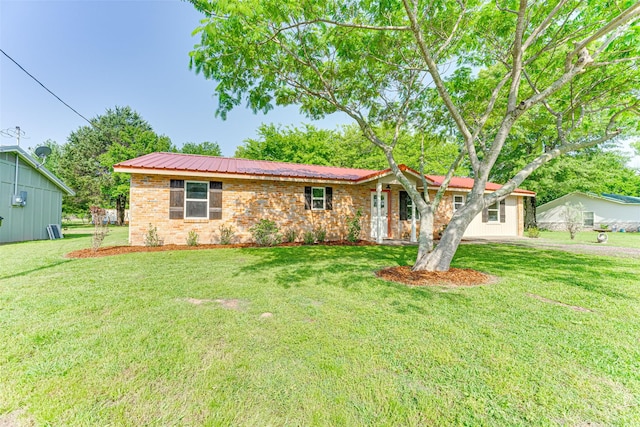 ranch-style home with a front lawn and metal roof