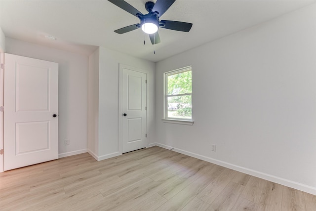 unfurnished bedroom featuring baseboards, light wood-type flooring, and ceiling fan