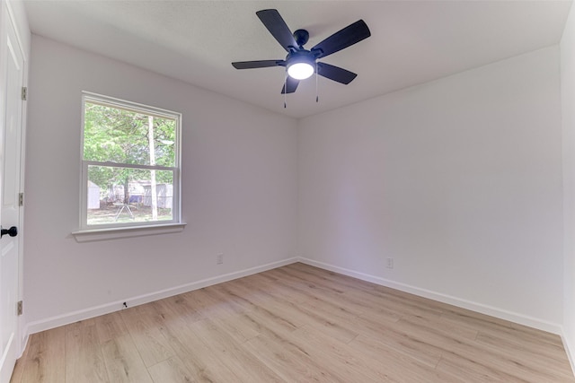 spare room featuring baseboards and light wood-type flooring
