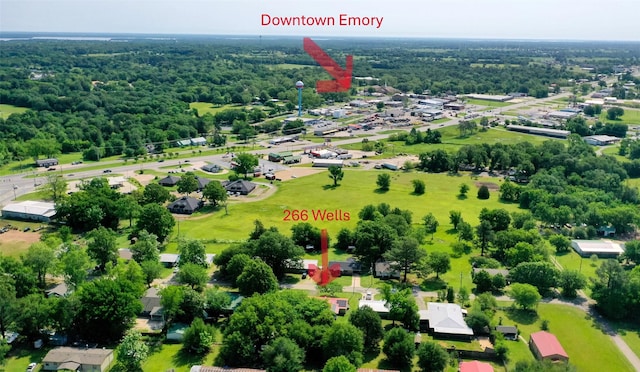 birds eye view of property featuring a wooded view