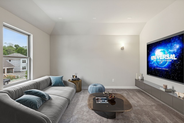 carpeted living area featuring lofted ceiling and baseboards