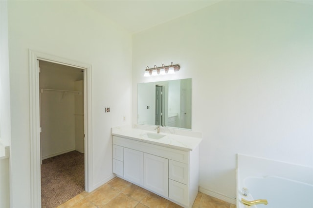 7404 Maybrook Ct, Plano, TX 75024 - full bathroom featuring vanity, a spacious closet, a bathtub, and tile patterned floors
