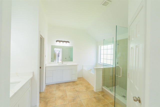 7404 Maybrook Ct, Plano, TX 75024 - bathroom with two vanities, a shower stall, a garden tub, lofted ceiling, and tile patterned floors