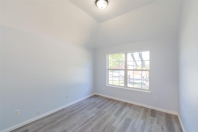 7404 Maybrook Ct, Plano, TX 75024 - empty room featuring light wood-style flooring, lofted ceiling, and baseboards