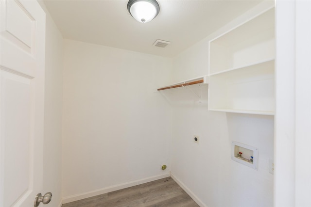 7404 Maybrook Ct, Plano, TX 75024 - washroom with washer hookup, light wood-type flooring, hookup for an electric dryer, and baseboards