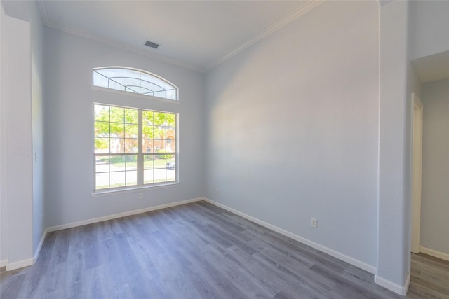 7404 Maybrook Ct, Plano, TX 75024 - spare room with wood finished floors, crown molding, and baseboards